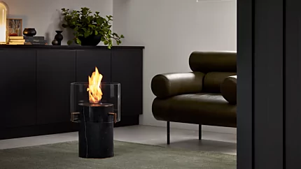 EcoSmart Fire Pillar 3T Designer Fireplace showcases a freestanding bioethanol column in an indoor private residence living area.